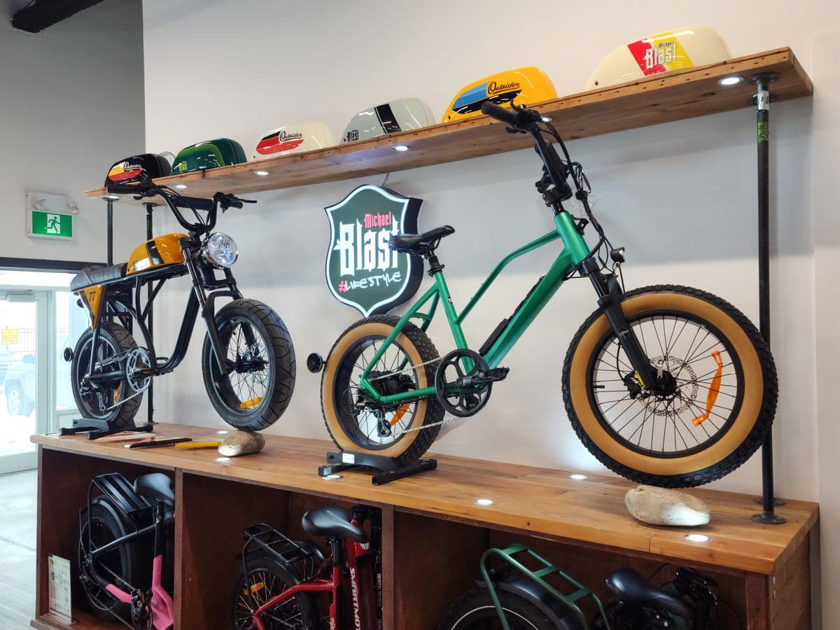 Michael Blast showroom wall display with electric bikes and branded fenders
