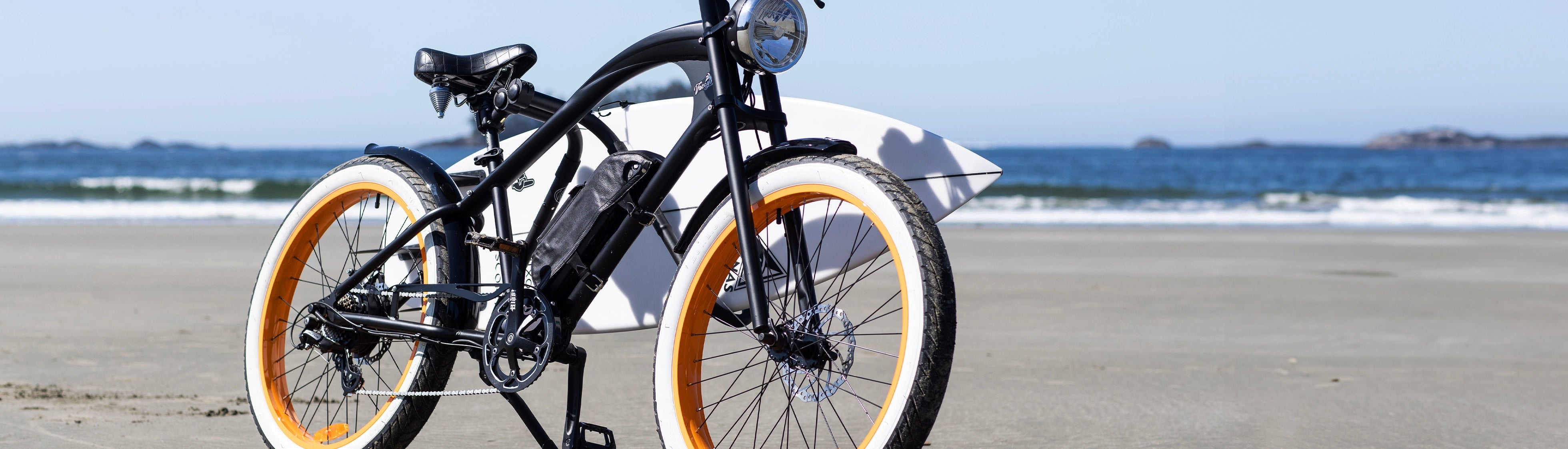 Michael Blast eBike on beach with surfboard