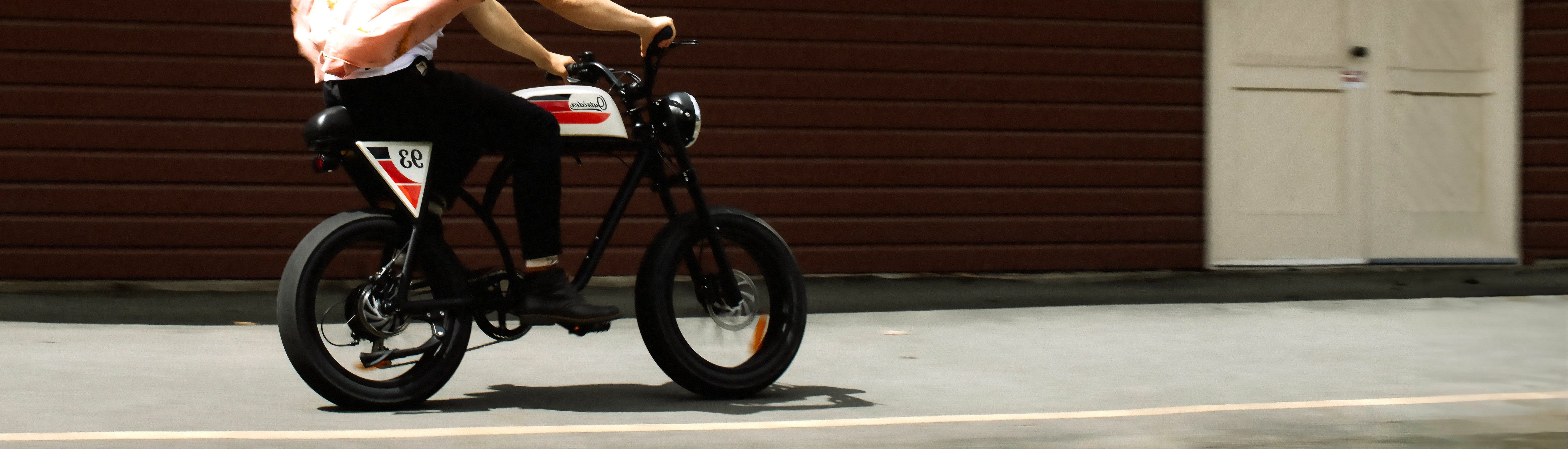 Individual riding eBike on sidewalk 