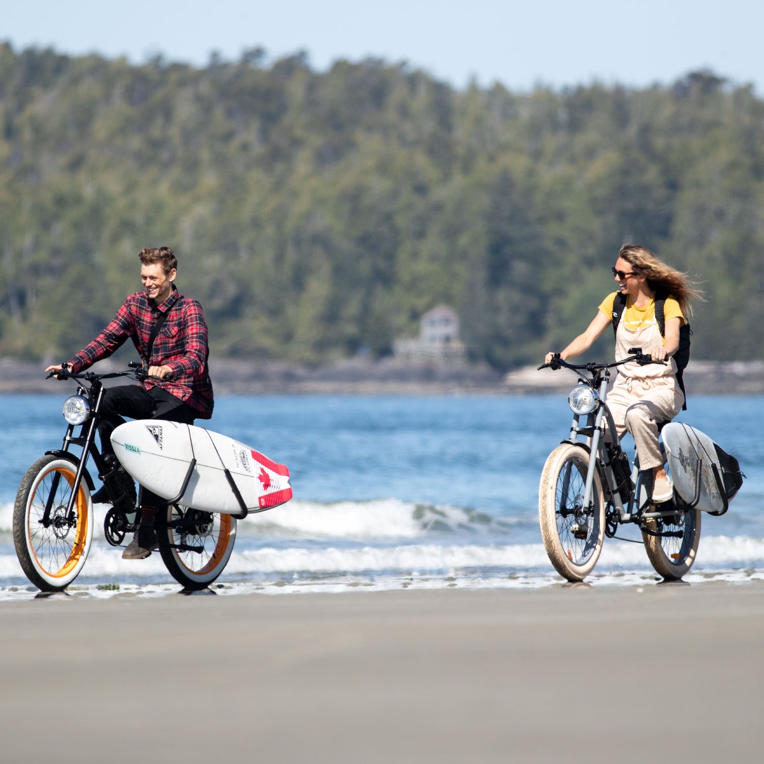 2 cyclists on beach with vintage electric bikes